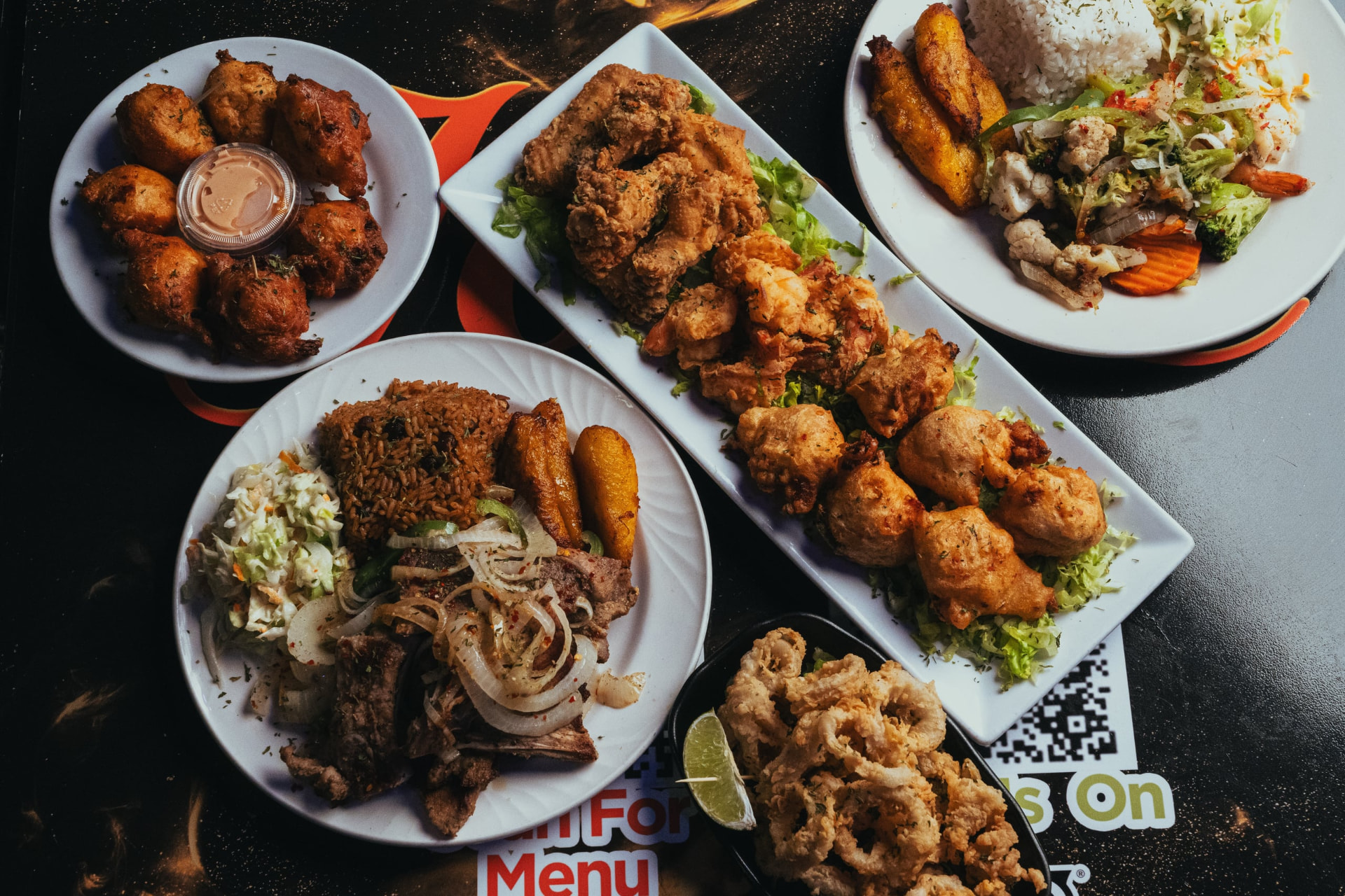 A full spread of Joey's fried seafood, wings and fritters